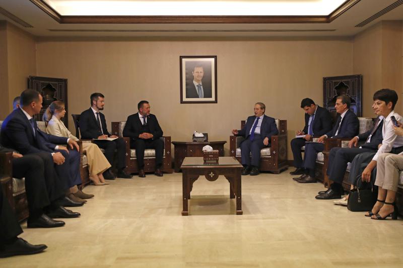 FILE - Syrian Foreign Minister Faisal Mekdad, center right, meets with Russian lawmaker Dmitry Sablin, center left, and a Russian delegation in Damascus, Syria, June 14, 2022. Sablin visited Syria with a Russian delegation that included the foreign minister for the breakaway pro-Russian area in Ukraine, the "Donetsk People's Republic." Syria said Wednesday, June 29, 2022, that it has it has decided to recognize the “independence and sovereignty” of Ukraine’s eastern Luhansk and Donetsk regions and contacts will be underway to have diplomatic relations. (AP Photo/Omar Sanadiki, File)